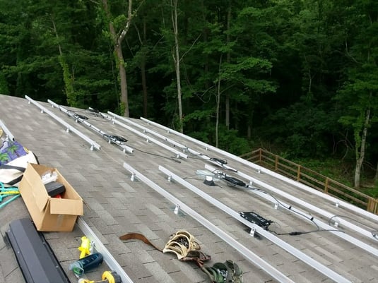 Mounting the solar panel racks to the roof